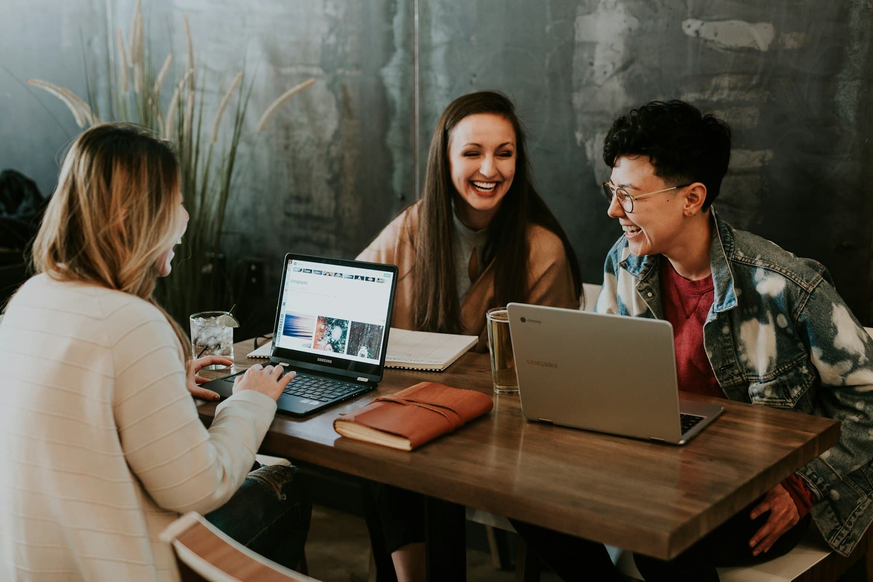 Three people working through a problem together at a shared table