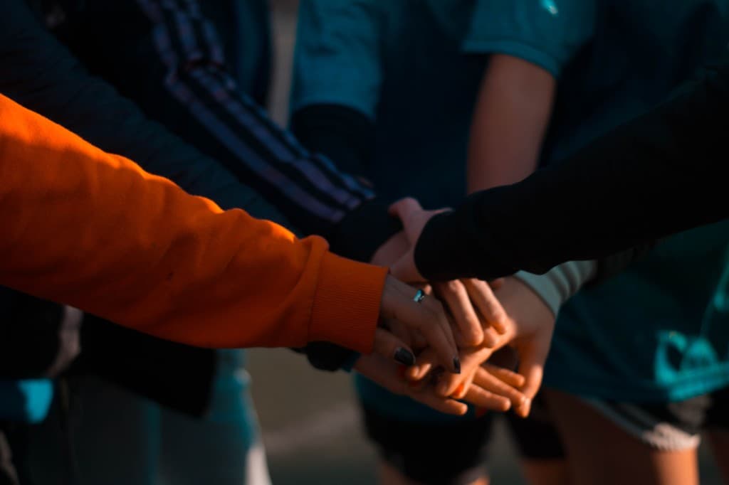 A group stacking their hands together