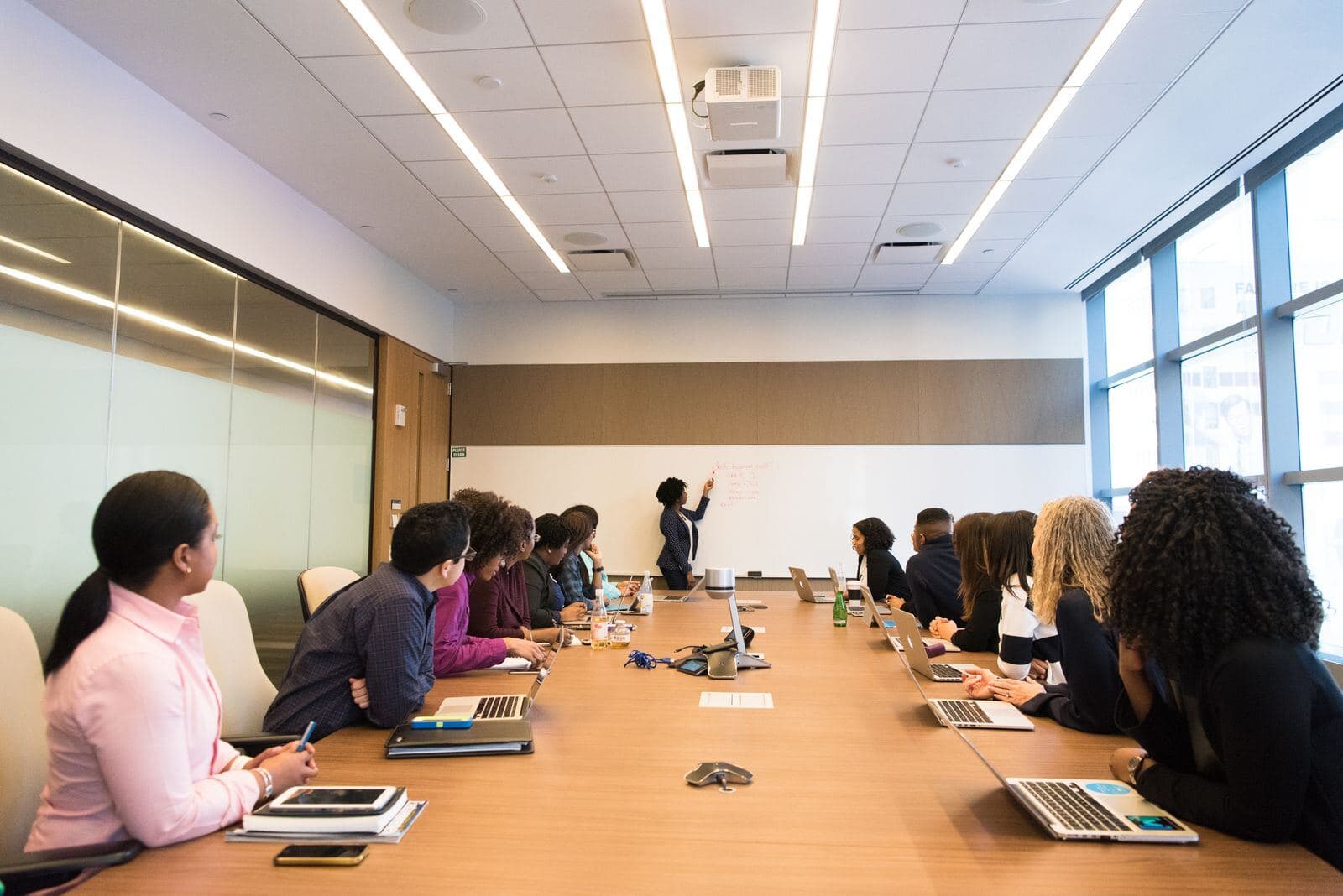 A seminar in session, with a tutor at the board and students around the table